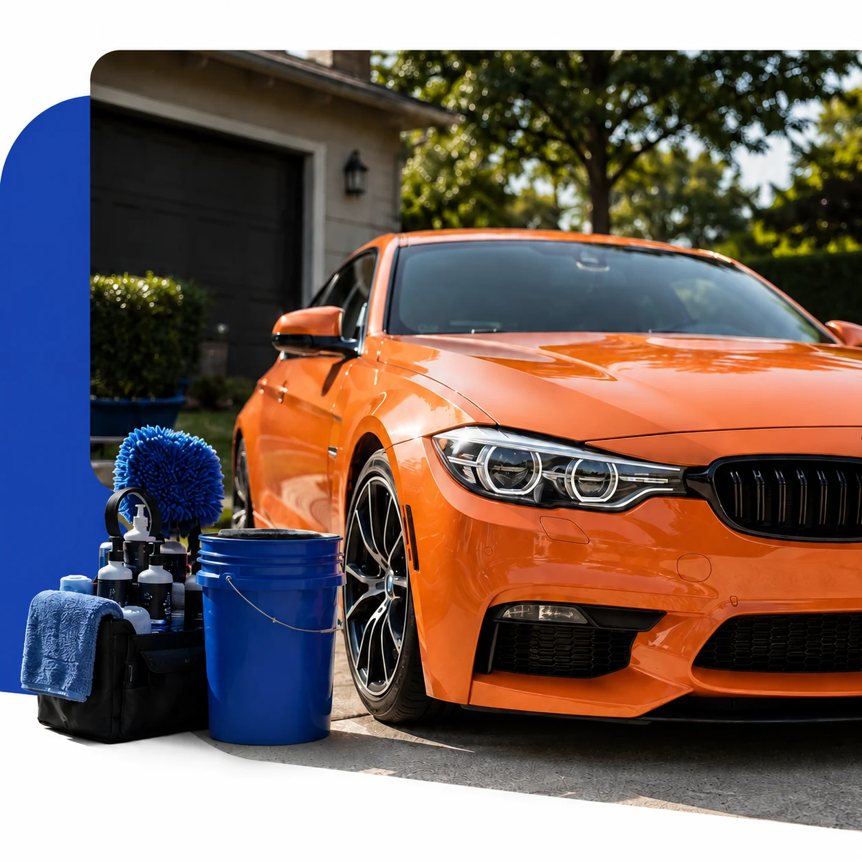 Orange coupe and mobile detailing equipment with a plain blue bucket in a driveway
